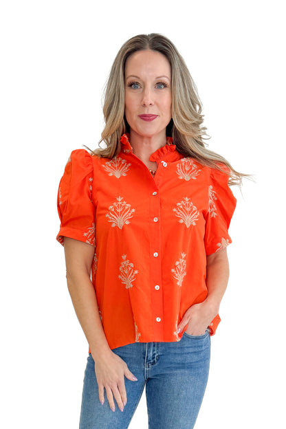 Front view of woman wearing Orange Embroidered Button Up Top by Entro with jeans against white studio background.