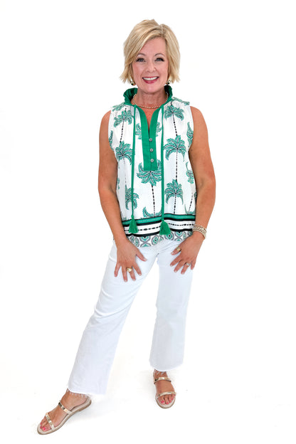 Front view of woman wearing Green Palm Printed Sleeveless Top by Entro with jeans against white studio background.