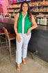 Front view of woman wearing Green Scallop Hem Center Stripe Tank by Entro with jeans at a bar.