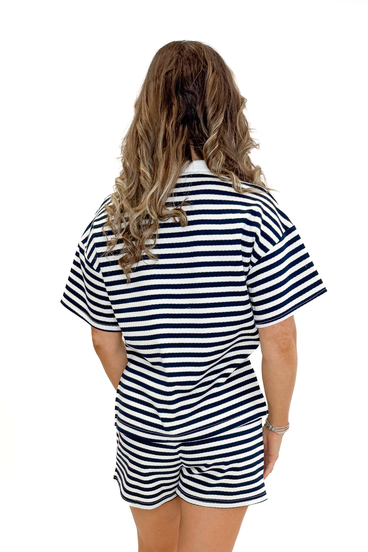 Back view of woman wearing Navy &amp; White Striped Shorts by Entro with matching Navy &amp; White Striped Collared Top by Entro against white studio background.