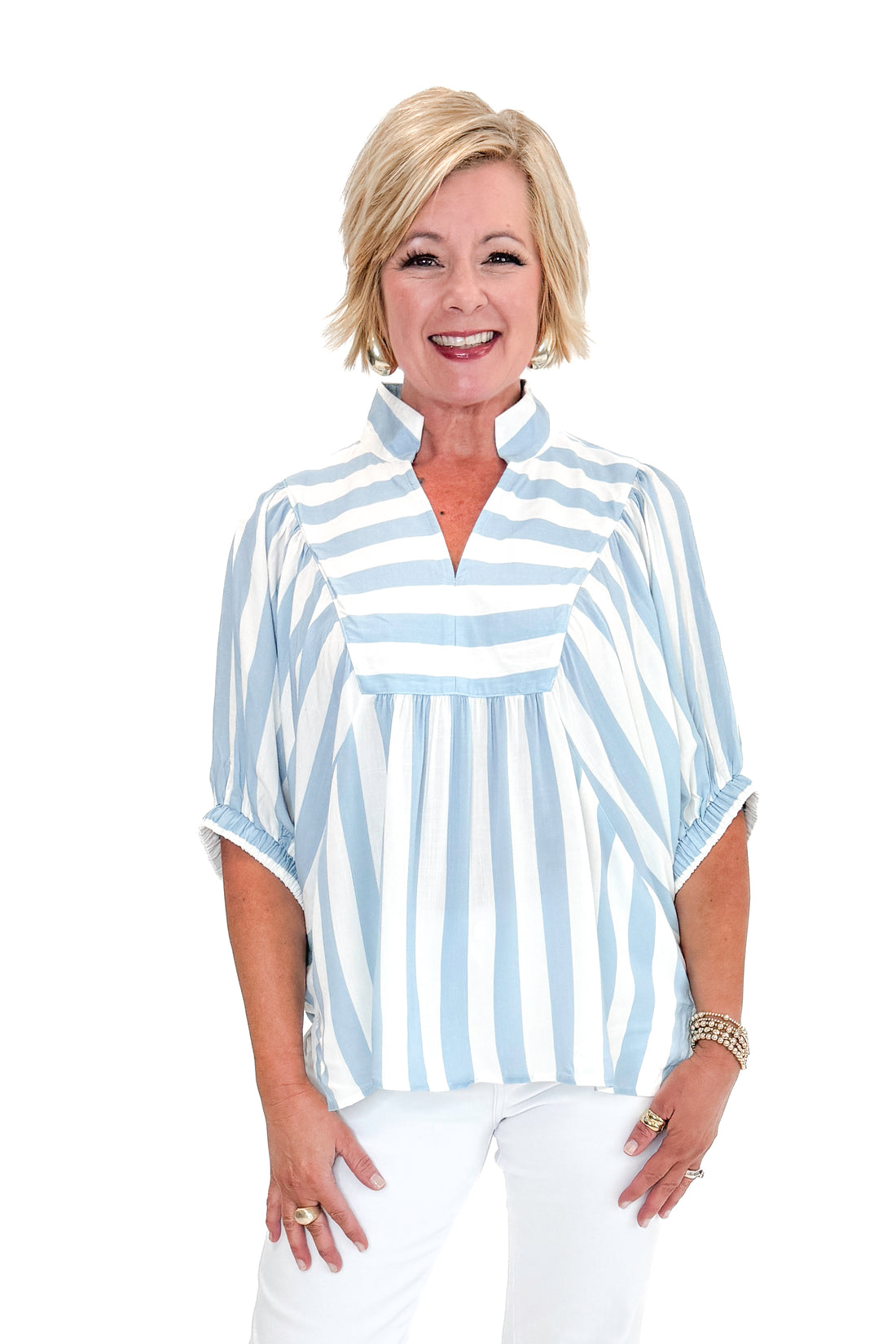Front view of woman wearing Light Blue Stripe Detail V-Neck Top by Entro with jeans against white studio background.