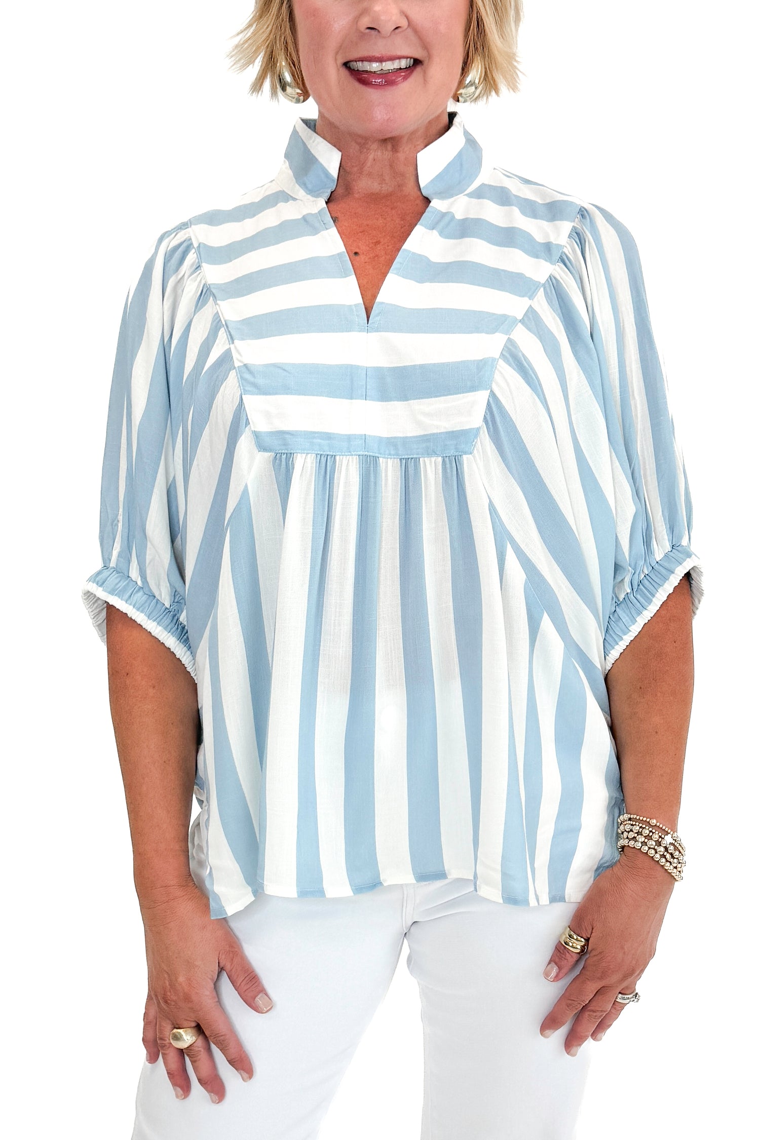 Front detail view of woman wearing Light Blue Stripe Detail V-Neck Top by Entro with jeans against white studio background.