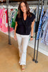 Front view of woman wearing Black Faux Layered Sweater Tank by Entro with jeans at Swagger boutique