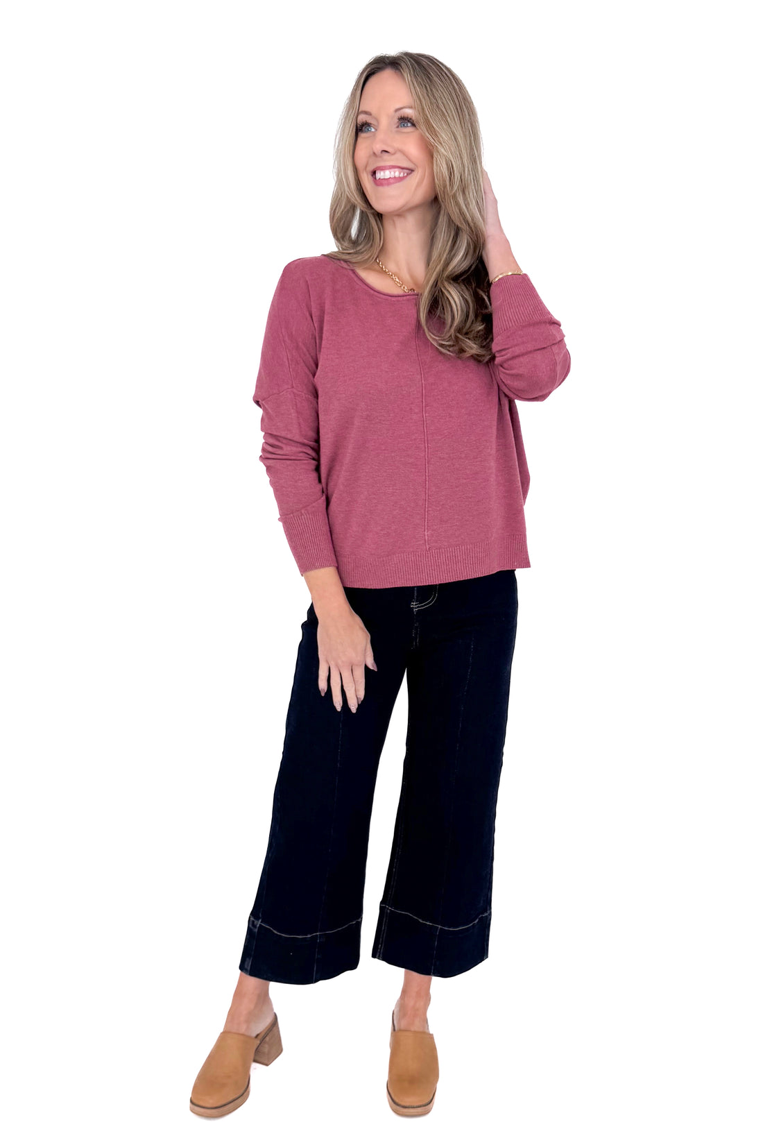 Front view of woman wearing Heathered Berry Center Seam Sweater and blue jeans.