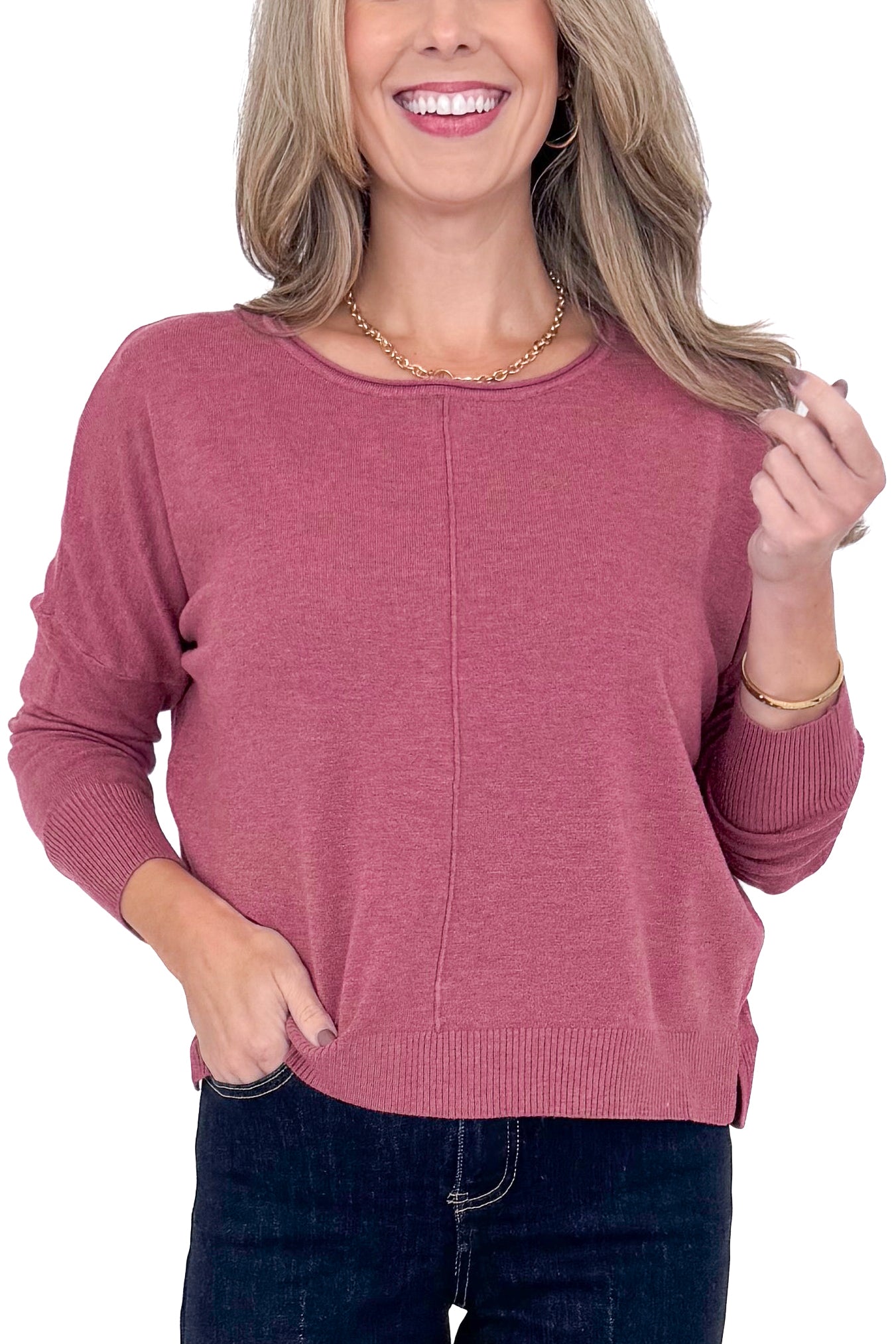 Front detailed view of woman wearing Heathered Berry Center Seam Sweater and blue jeans. 
