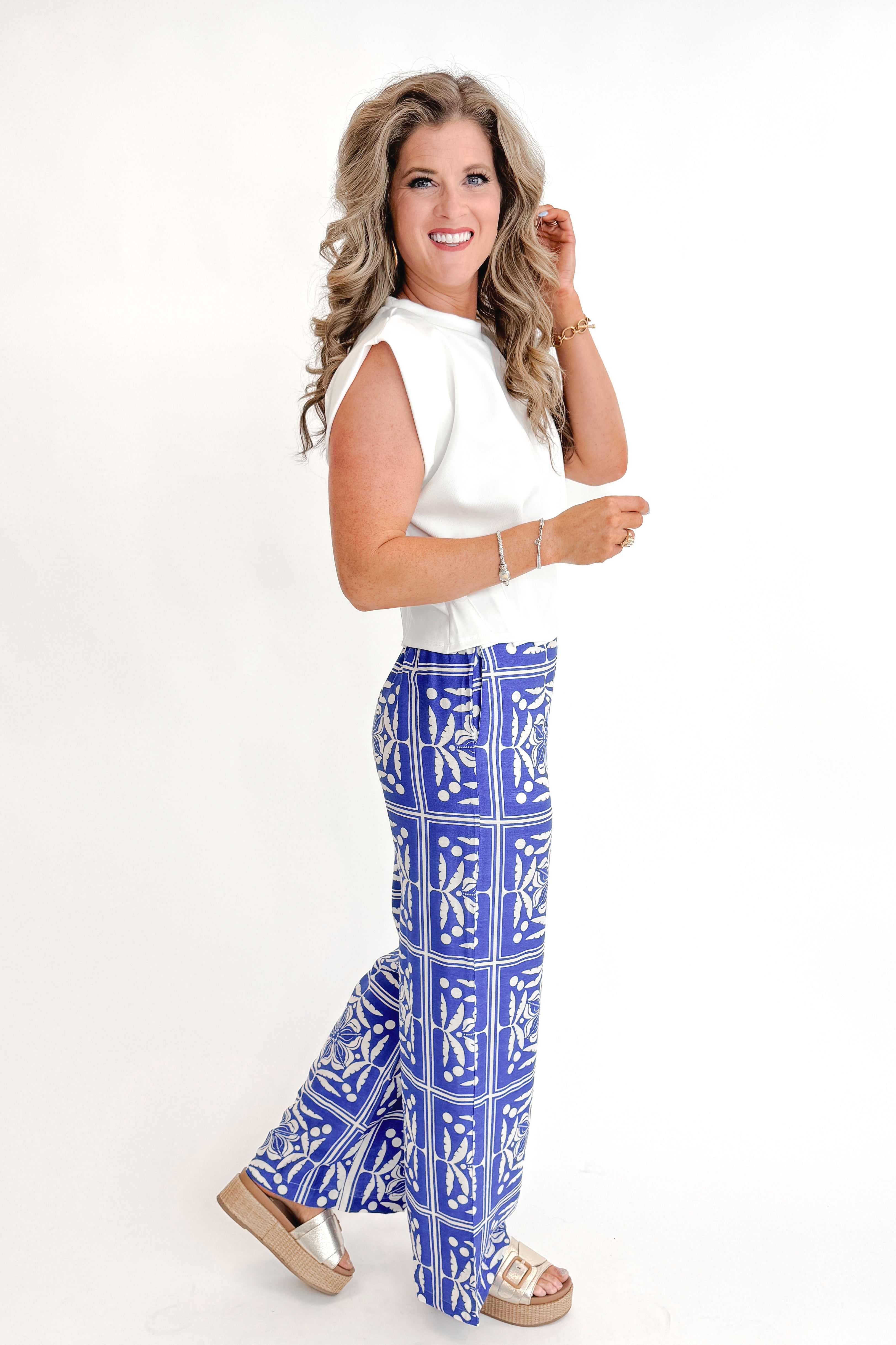 Front view of woman wearing Blue Floral Print Wide Leg Pants with top against white studio background.