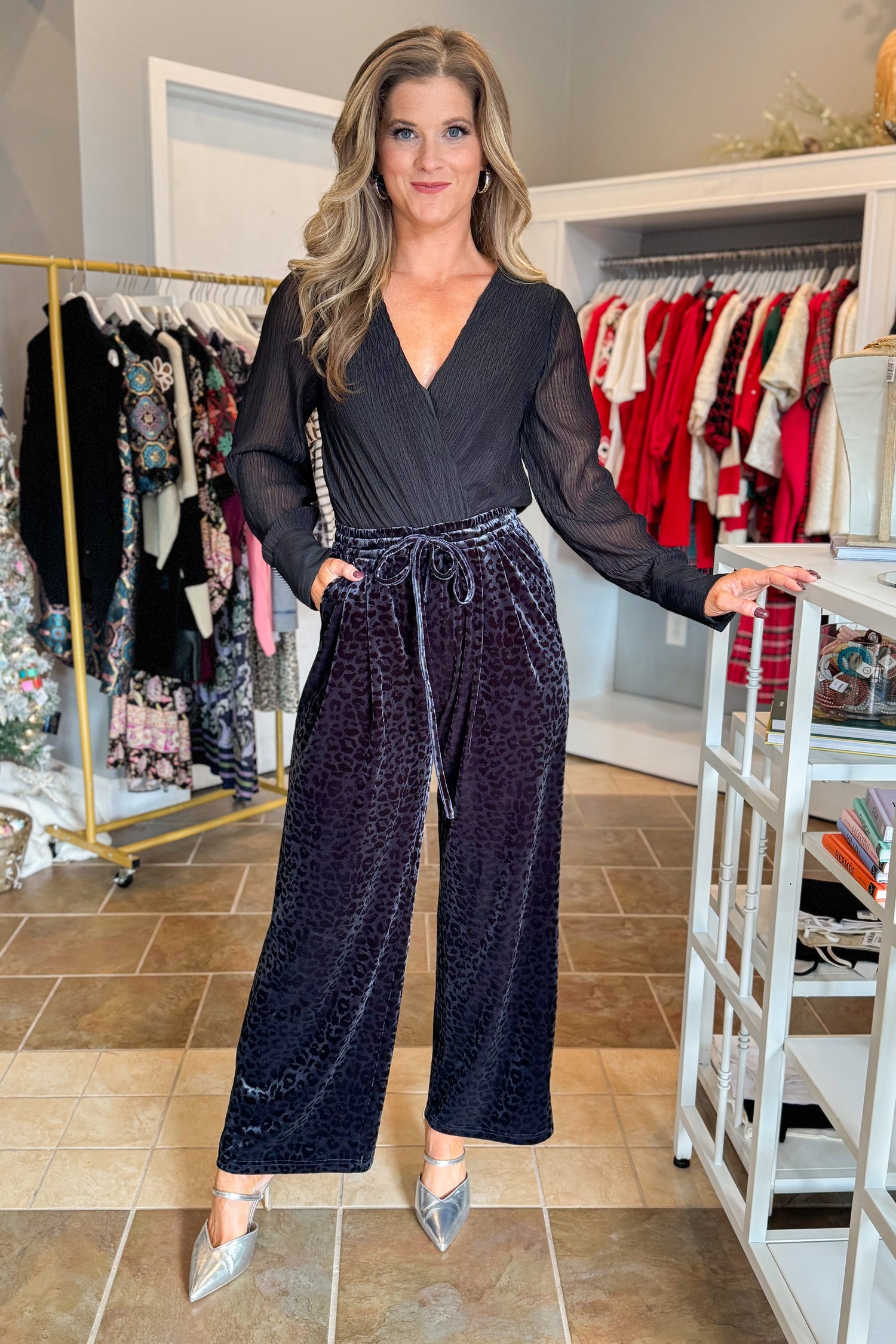 Front view of woman wearing Navy Velvet Leopard Print Pants with bodysuit at a boutique