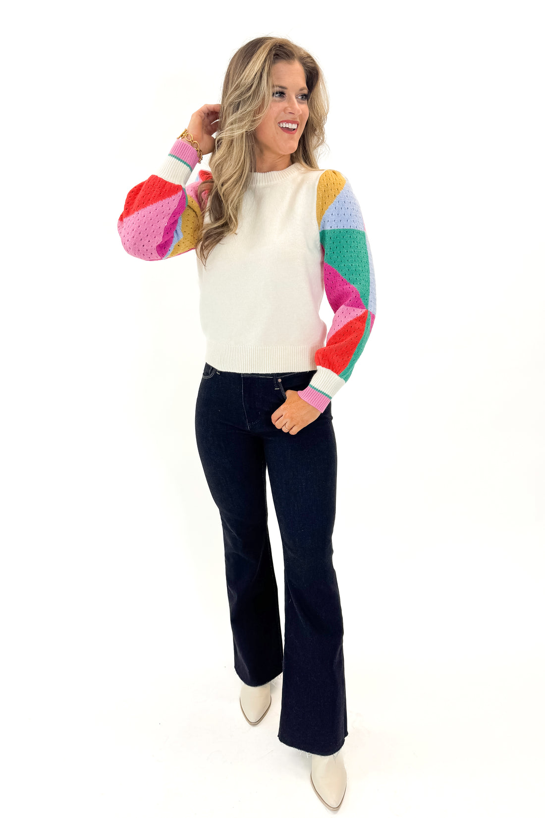 Front view of model wearing Cream With Multi Colored Sleeve Sweater by THML with jeans against a white background.