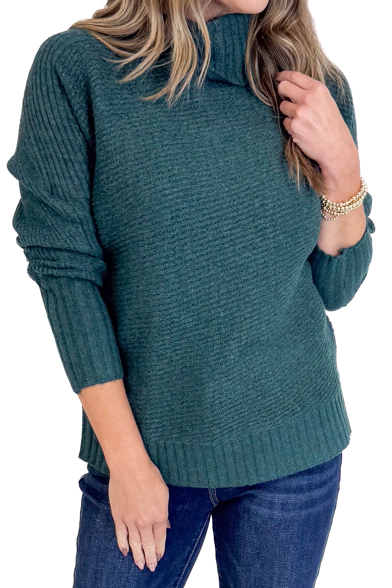 Person wearing a dark green sweater with a white background