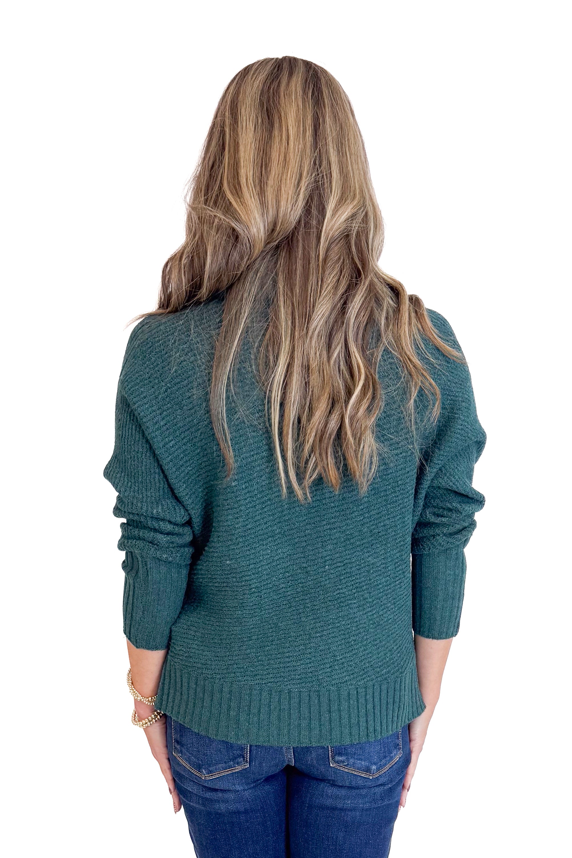 Person wearing a dark green sweater from behind on a white background