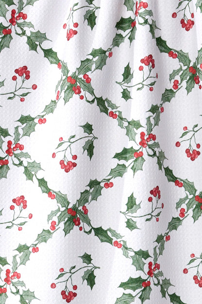 Curtain with holly leaf and berry pattern on a white background