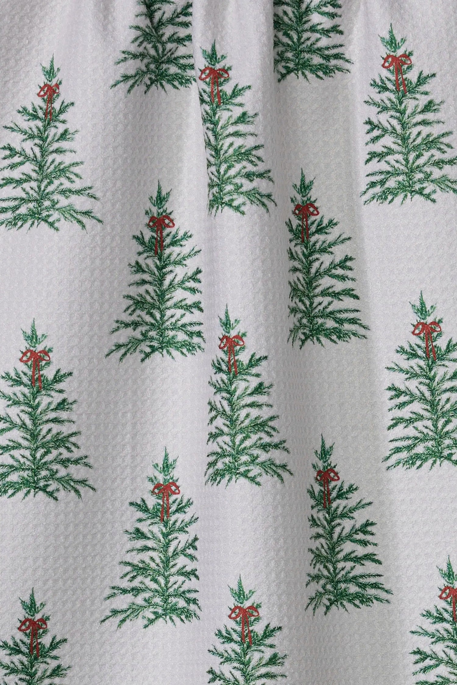 Pattern of green trees with red berries on a white background