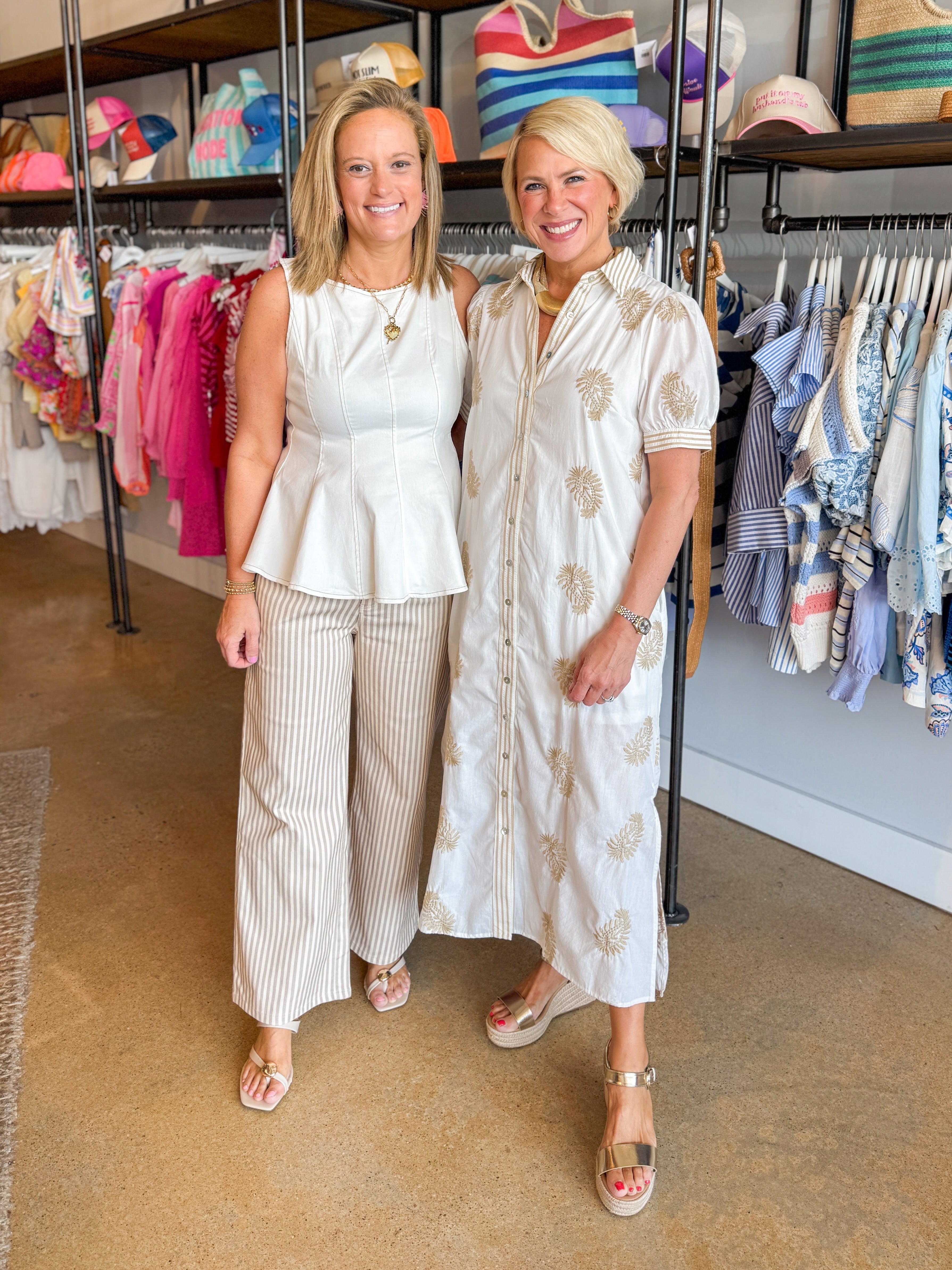 Front view of woman wearing Swagger Boutique’s Off White Paneled Peplum Top by Entro with stripe jeans and woman wearing dress at the boutique.