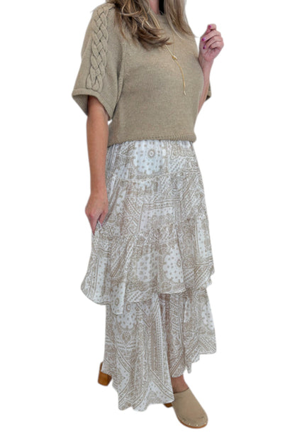 Side detail view of woman wearing Swagger Boutique’s Taupe Bandana Print Tiered Skirt with Oatmeal Braid Detail Short Sleeve Sweater by Entro against white studio background.
