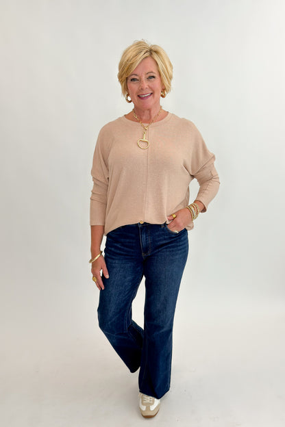 Front view of woman wearing Swagger Boutique’s Taupe Brushed Center Seam Top with jeans against white studio background.