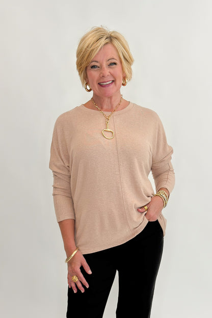 Front view of woman wearing Swagger Boutique’s Taupe Brushed Center Seam Top with jeans against white studio background.