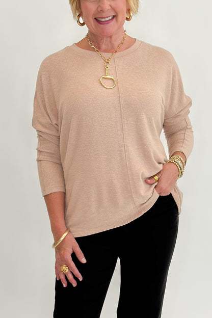 Front detail view of woman wearing Swagger Boutique’s Taupe Brushed Center Seam Top with jeans against white studio background.