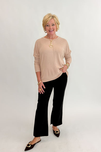 Front view of woman wearing Swagger Boutique’s Taupe Brushed Center Seam Top with jeans against white studio background.