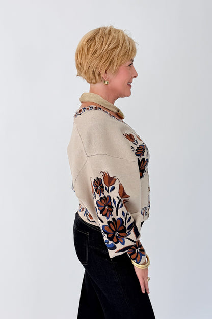 Side view of woman wearing Swagger Boutique’s Taupe Printed V-Neck Cardigan with jeans against white studio background.
