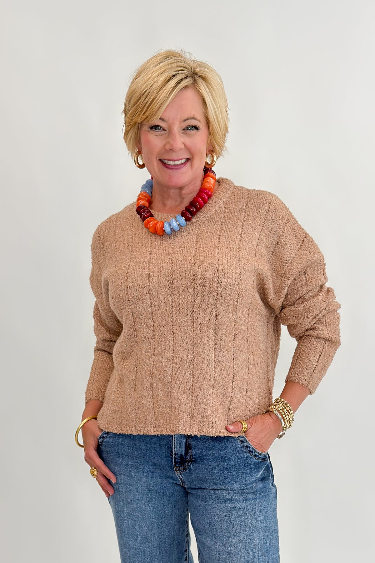 Front view of woman wearing Swagger Boutique’s Taupe Ribbed Textured Sweater with Maya Wide Leg Jeans In Medium Wash- Journey by Kut from the Kloth against white studio background.