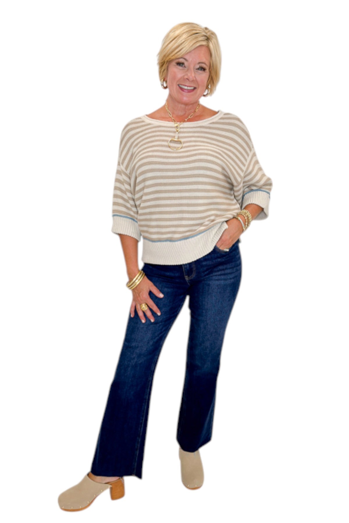 Front view of woman wearing Swagger Boutique’s Taupe Striped Short Sleeve Sweater with jeans against white studio background.
