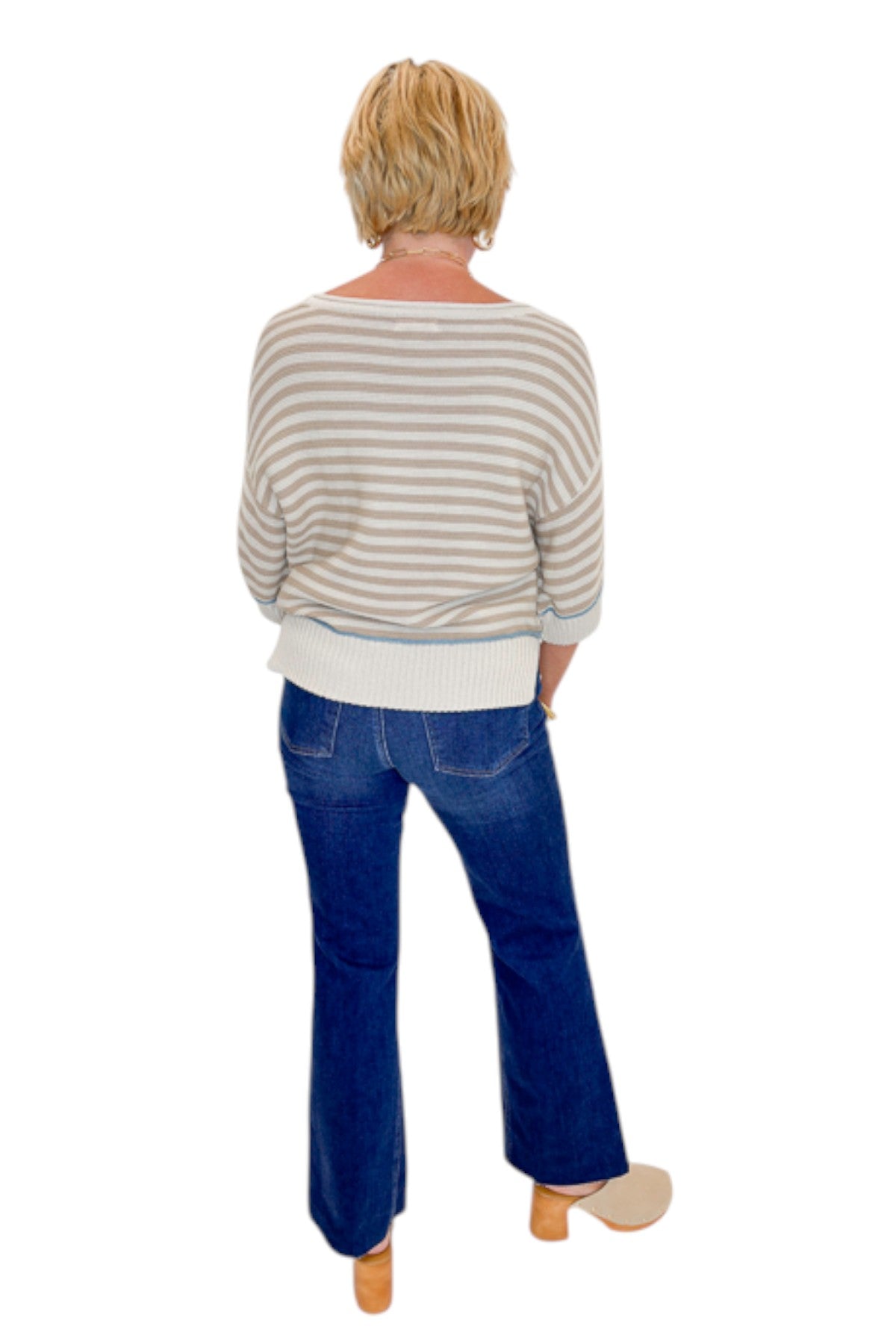 Back view of woman wearing Swagger Boutique’s Taupe Striped Short Sleeve Sweater with jeans against white studio background.