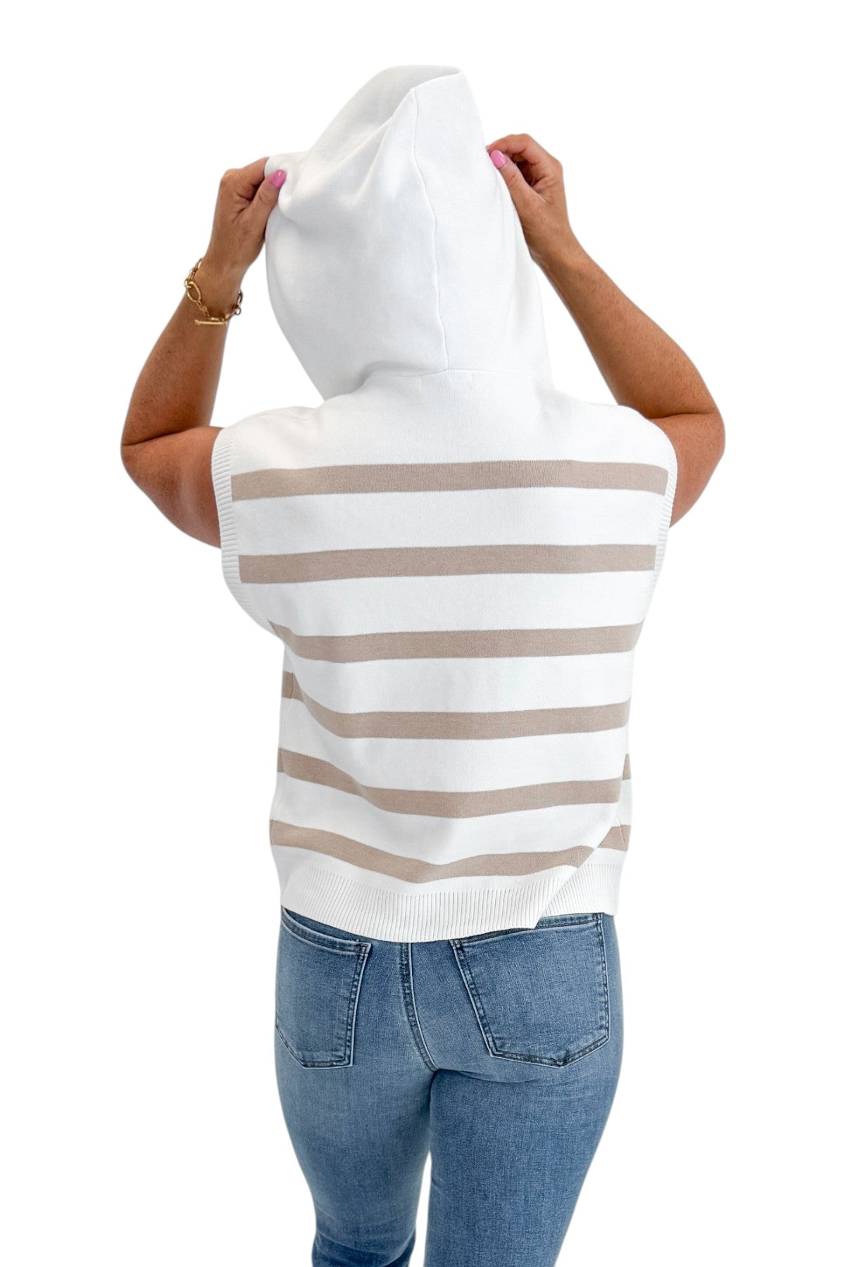 Back view of woman wearing Swagger Boutique’s Taupe Striped Sleeveless Sweater with jeans against white studio background.