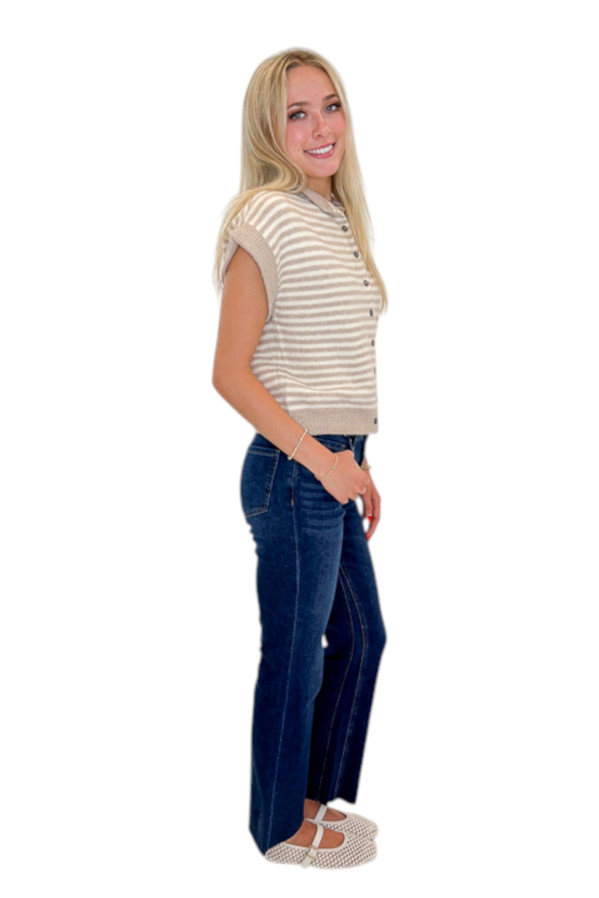 Side view of woman wearing Swagger Boutique’s Taupe &amp; Cream Striped Sleeveless Sweater by Entro with jeans against white studio background.
