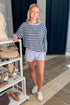 Front view of woman wearing Swagger Boutique’s Skyline The Everyday Short and Eclipse The Everyday Striped Crew by Z Supply standing at the store.
