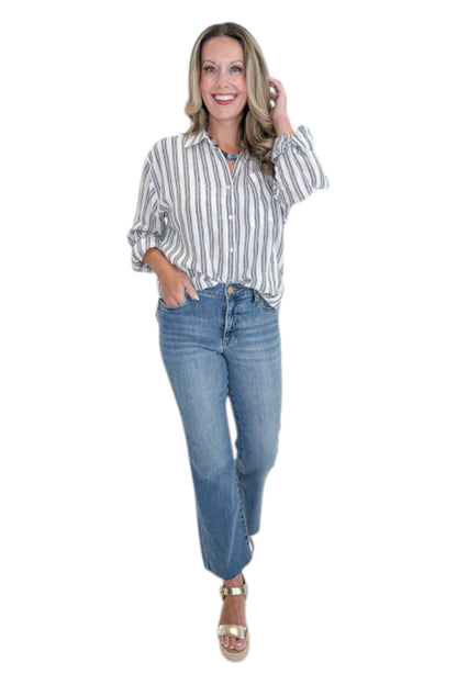 Front view of woman wearing Swagger Boutique’s White The Perfect Striped Button Up Top by Z Supply with jeans against white studio background.