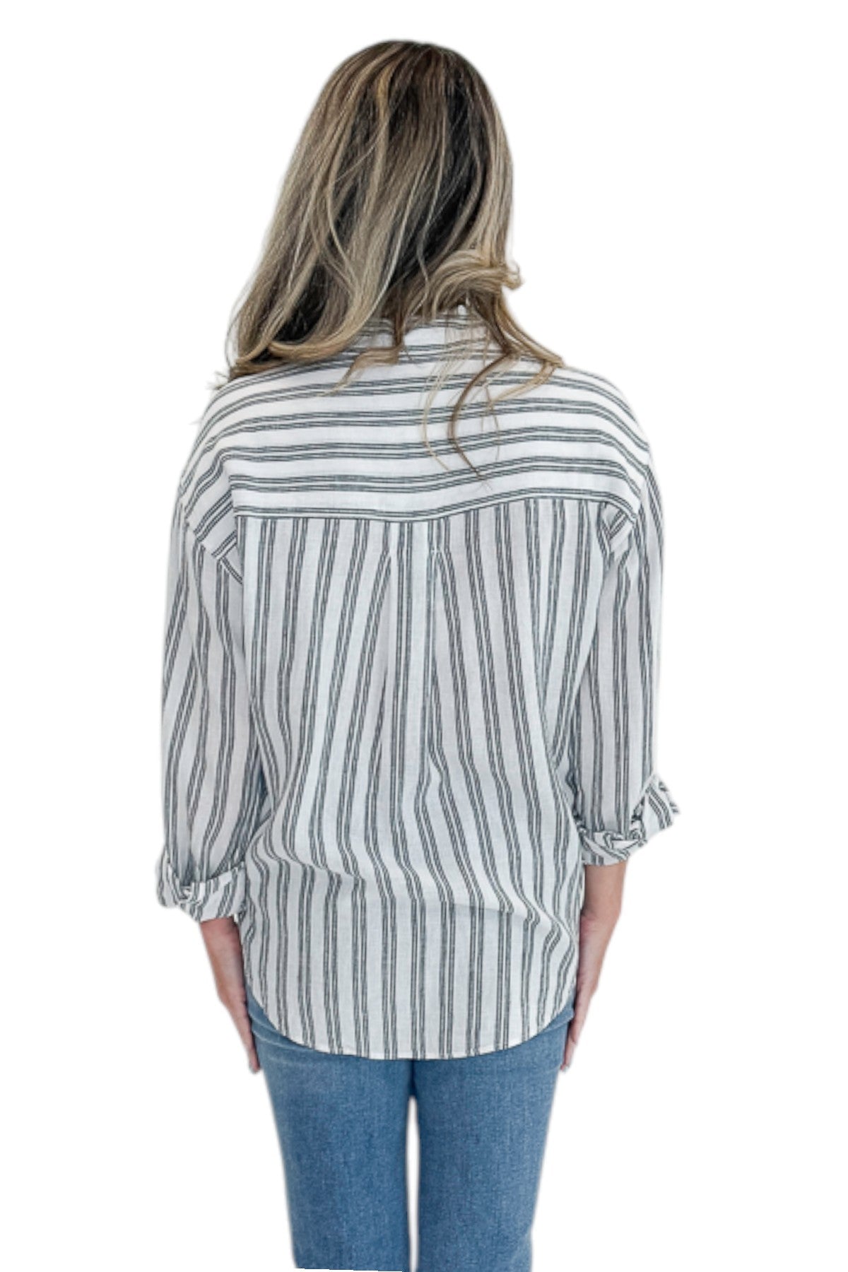 Back view of woman wearing Swagger Boutique’s White The Perfect Striped Button Up Top by Z Supply with jeans against white studio background.