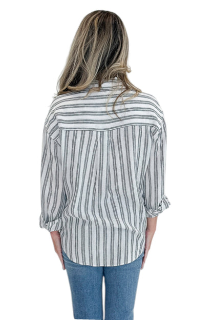 Back view of woman wearing Swagger Boutique’s White The Perfect Striped Button Up Top by Z Supply with jeans against white studio background.