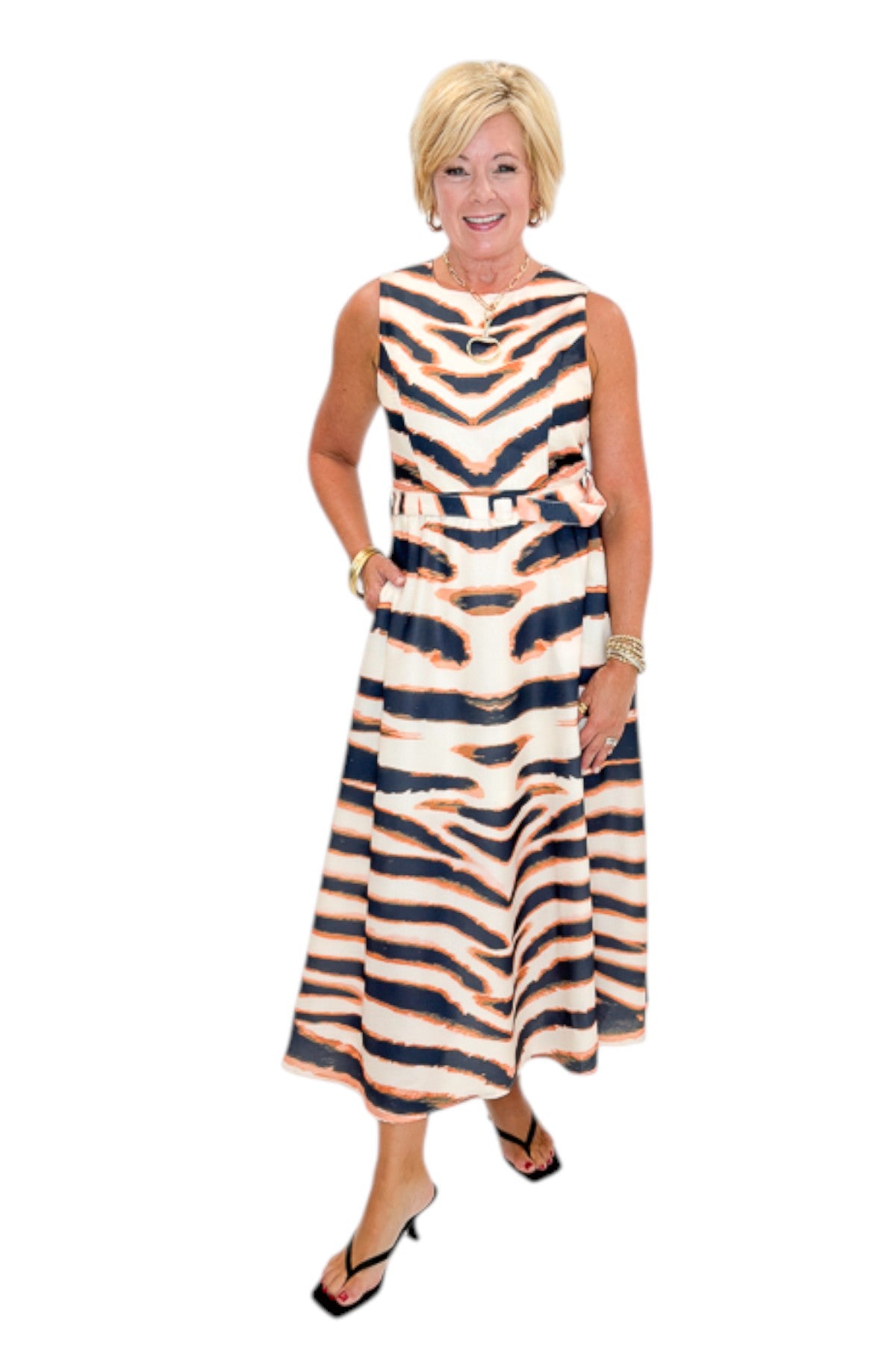 Front view of woman wearing Swagger Boutique’s Tiger Print Midi Dress by Entro with heels against white studio background.