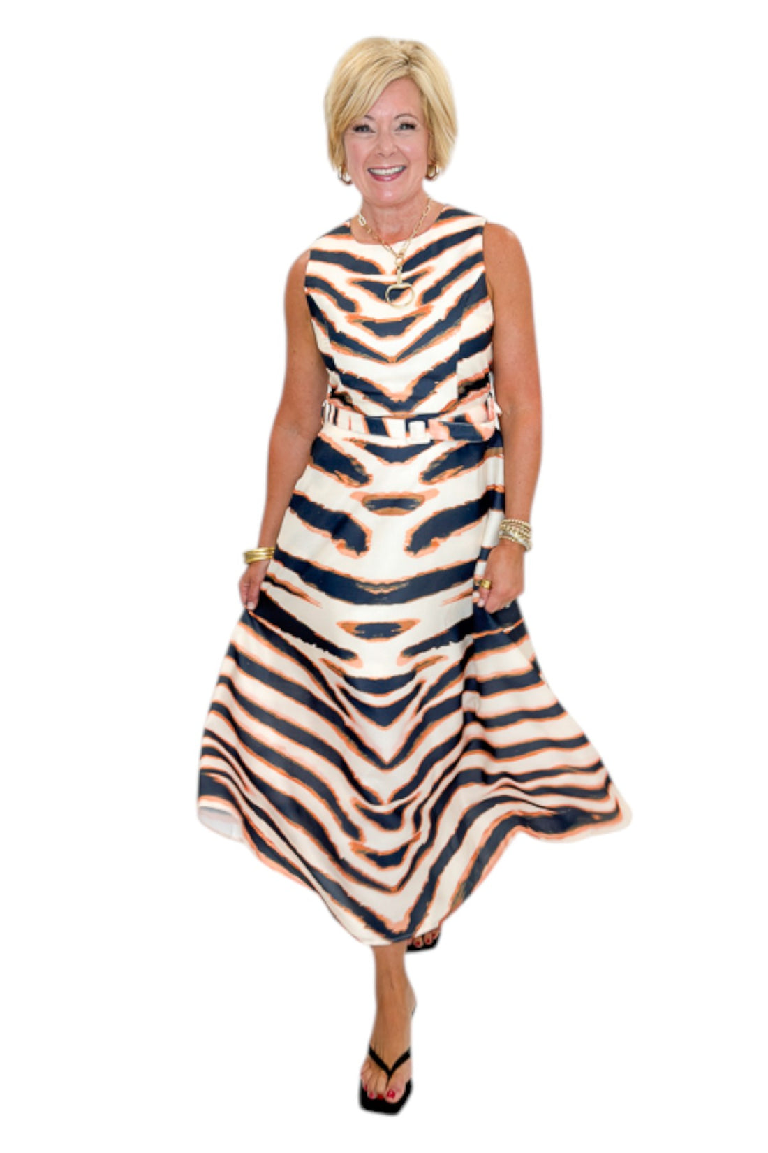 Front view of woman wearing Swagger Boutique’s Tiger Print Midi Dress by Entro with heels against white studio background.
