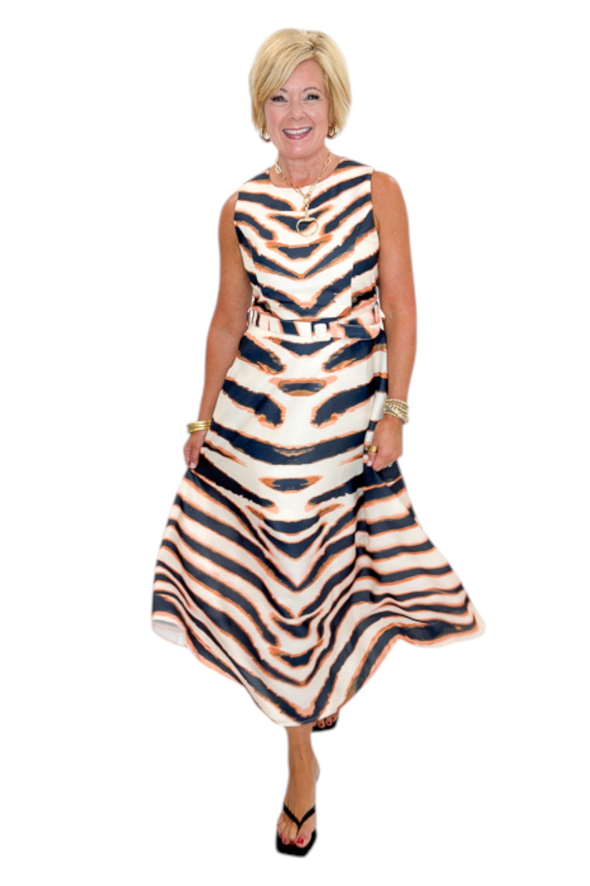 Front view of woman wearing Swagger Boutique’s Tiger Print Midi Dress by Entro with heels against white studio background.