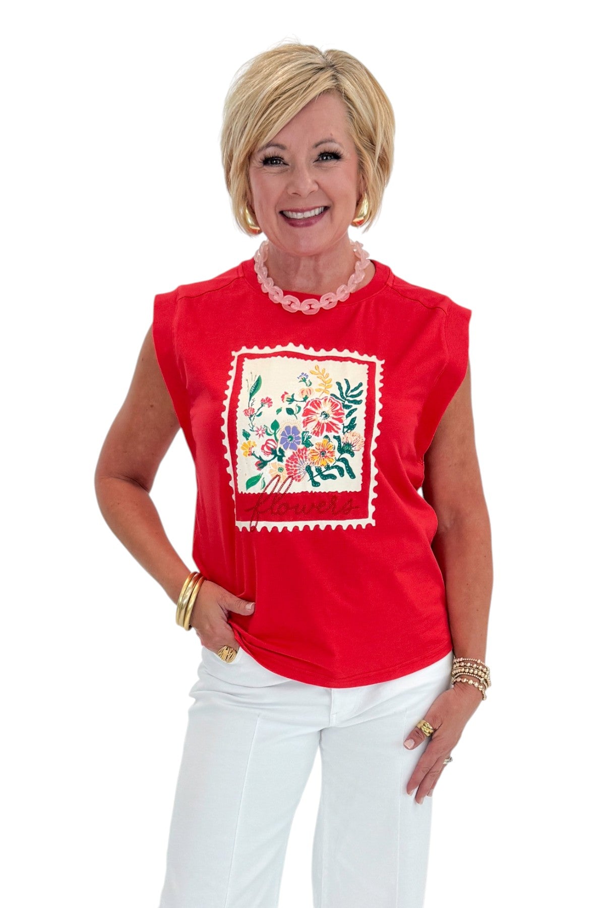 Front view of woman wearing Swagger Boutique’s Tomato Floral Graphic Tee with jeans against white studio background.