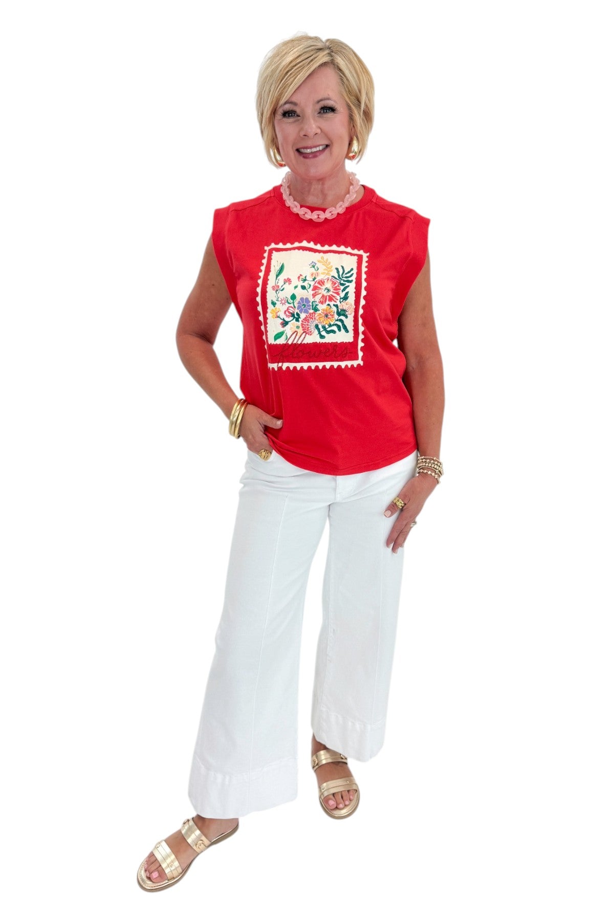 Front view of woman wearing Swagger Boutique’s Tomato Floral Graphic Tee with jeans against white studio background.