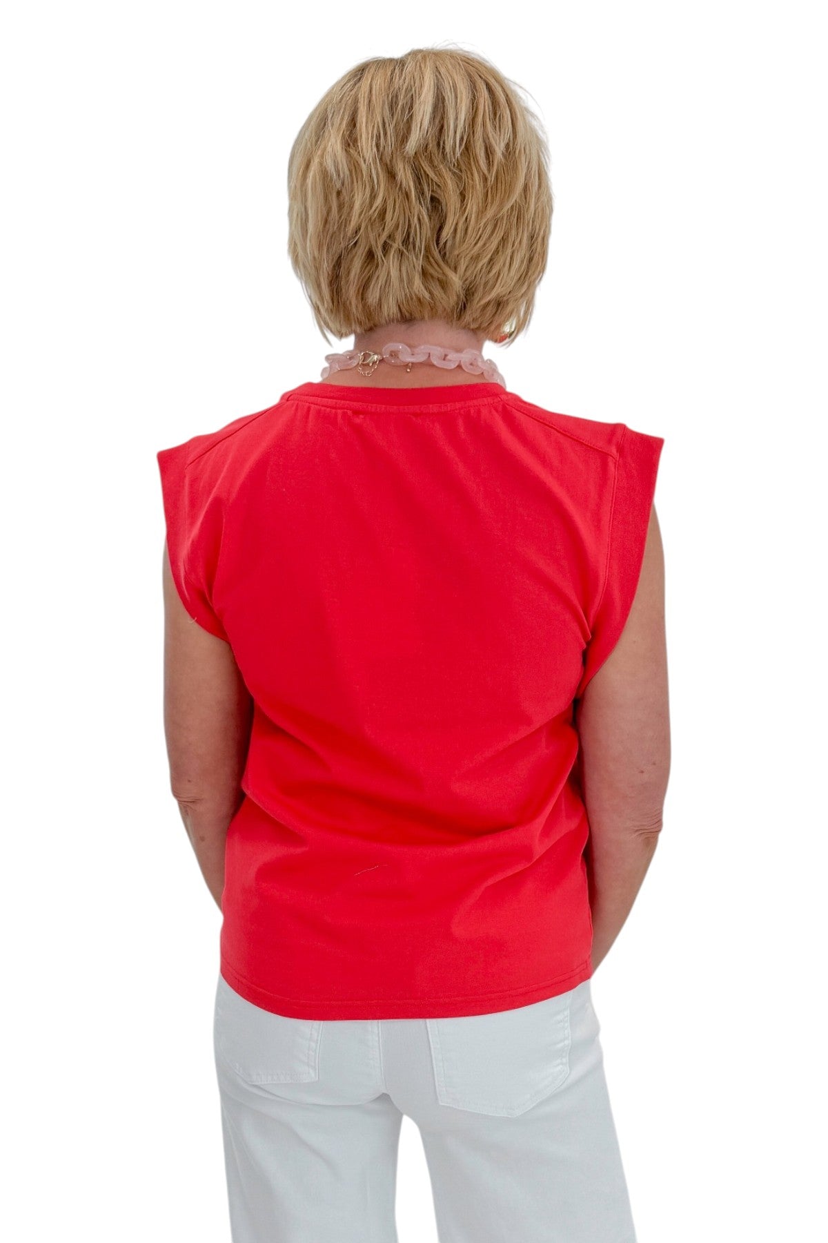 Back view of woman wearing Swagger Boutique’s Tomato Floral Graphic Tee with jeans against white studio background.