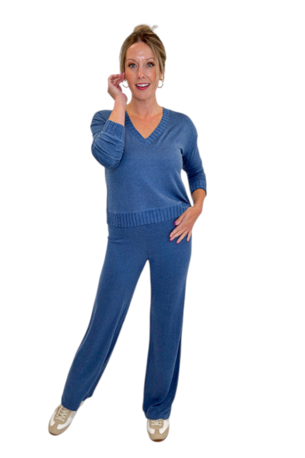 Front view of woman wearing Swagger Boutique’s True Navy Courtney Long Sleeve Top by Z Supply with True Navy Dawn Smocked Pants by Z Supply against white studio background.