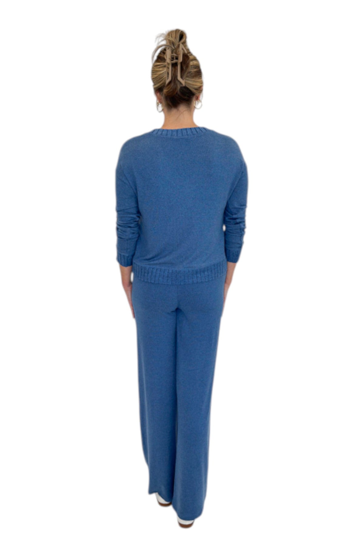 Back view of woman wearing Swagger Boutique’s True Navy Courtney Long Sleeve Top by Z Supply with True Navy Dawn Smocked Pants by Z Supply against white studio background.