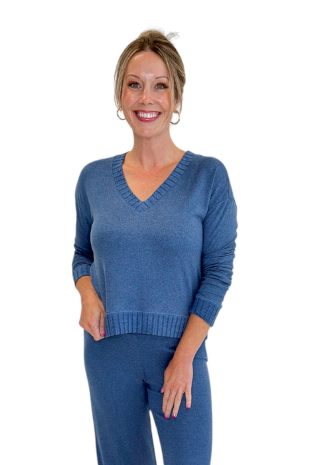 Front view of woman wearing Swagger Boutique’s True Navy Courtney Long Sleeve Top by Z Supply with True Navy Dawn Smocked Pants by Z Supply against white studio background.