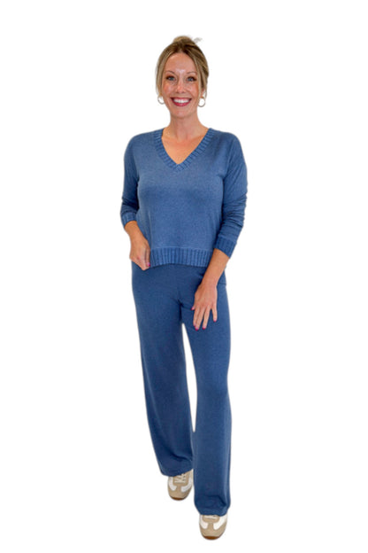 Front view of woman wearing Swagger Boutique’s True Navy Courtney Long Sleeve Top by Z Supply with True Navy Dawn Smocked Pants by Z Supply against white studio background.