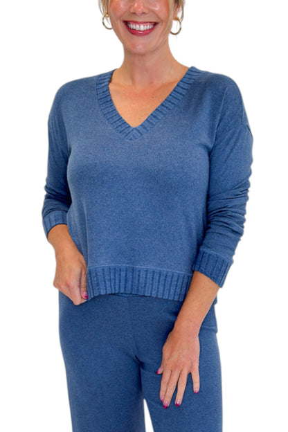 Front detail view of woman wearing Swagger Boutique’s True Navy Courtney Long Sleeve Top by Z Supply with True Navy Dawn Smocked Pants by Z Supply against white studio background.