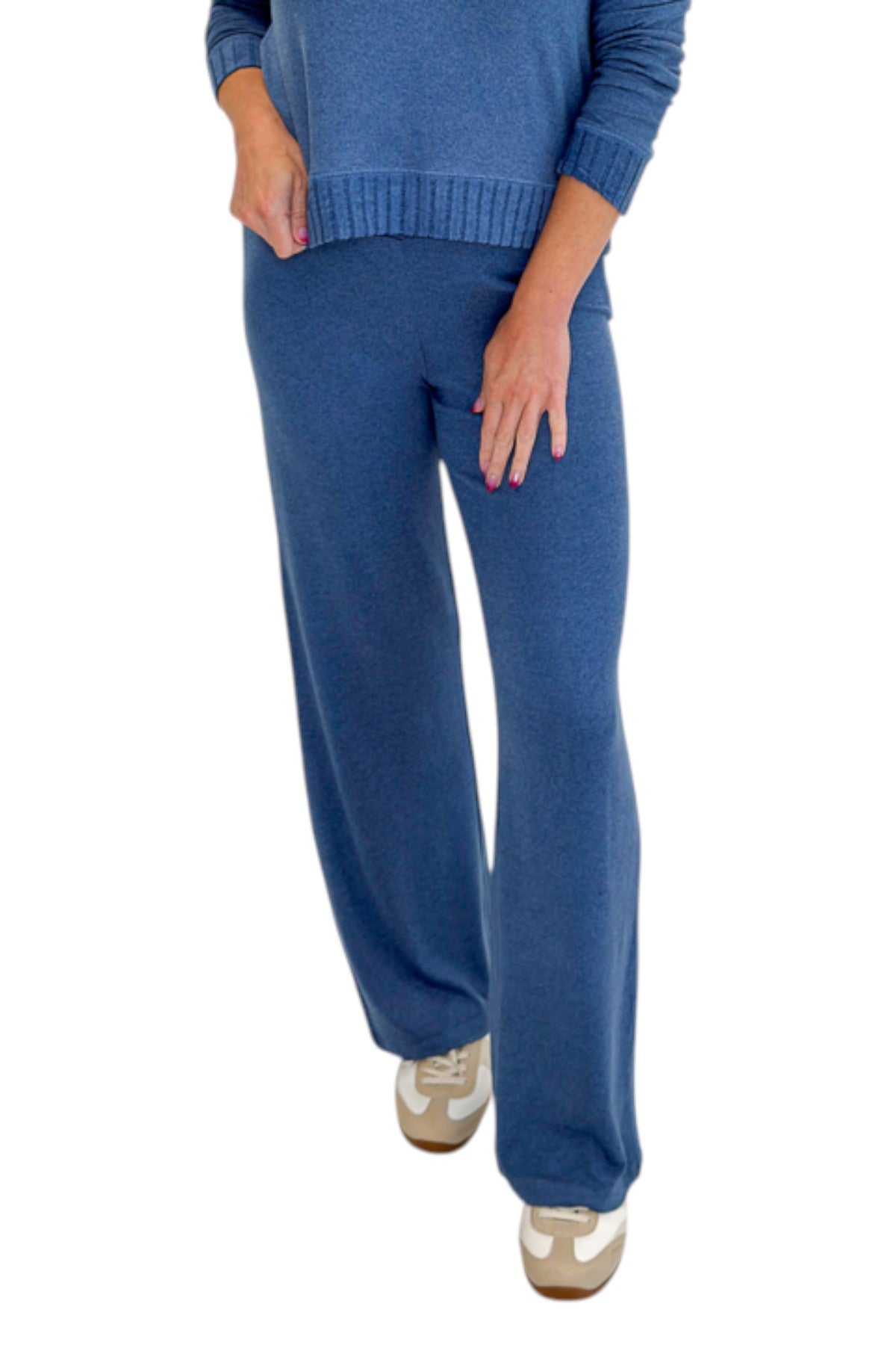Front detail view of woman wearing Swagger Boutique’s True Navy Courtney Long Sleeve Top by Z Supply with True Navy Dawn Smocked Pants by Z Supply against white studio background.