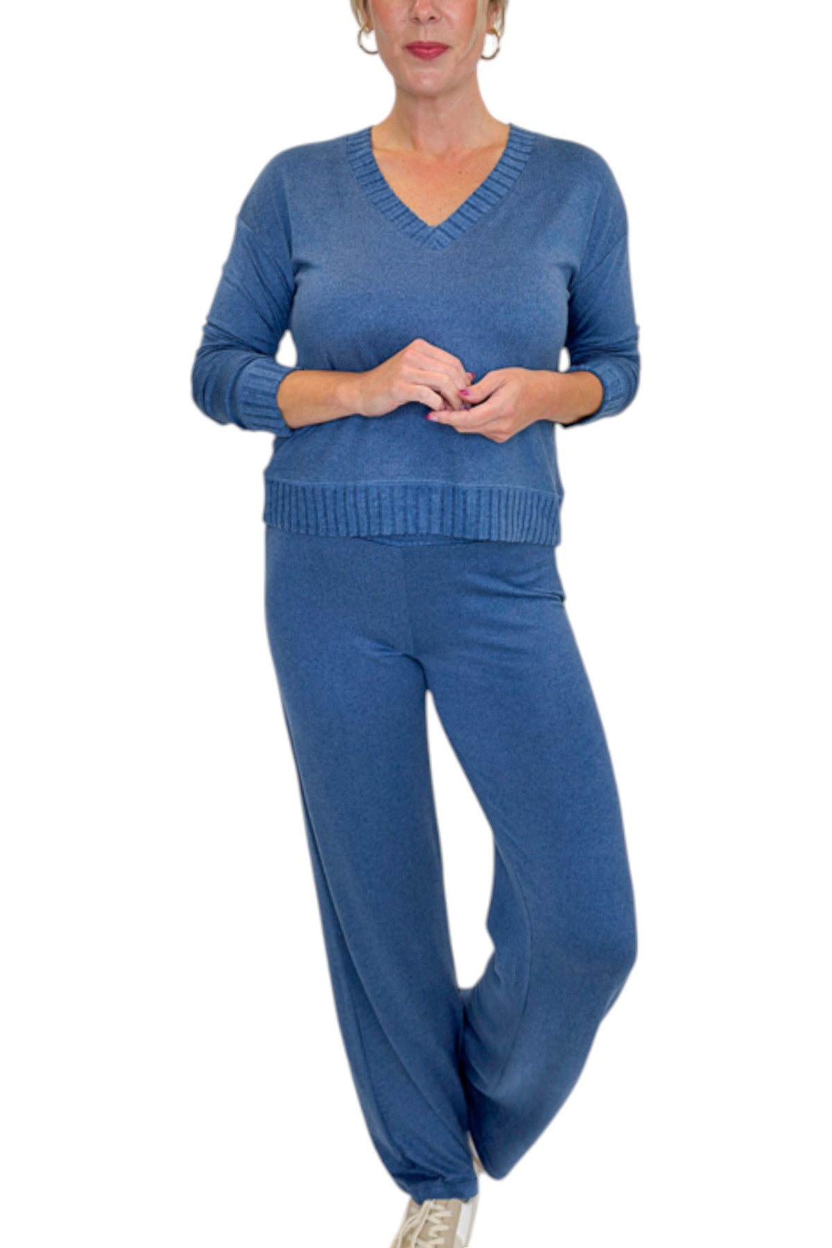 Front view of woman wearing Swagger Boutique’s True Navy Courtney Long Sleeve Top by Z Supply with True Navy Dawn Smocked Pants by Z Supply against white studio background.