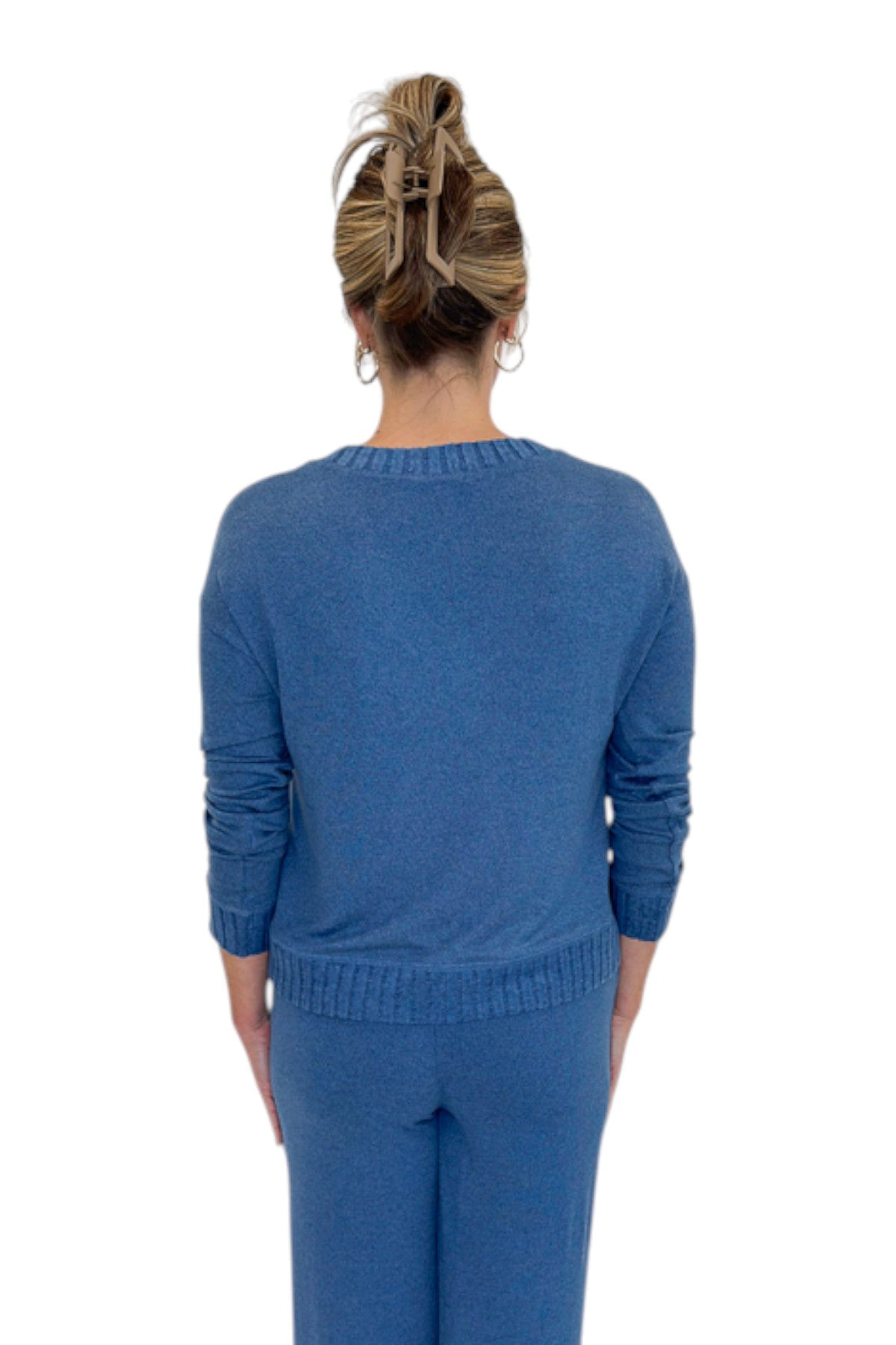 Back view of woman wearing Swagger Boutique’s True Navy Courtney Long Sleeve Top by Z Supply with True Navy Dawn Smocked Pants by Z Supply against white studio background.