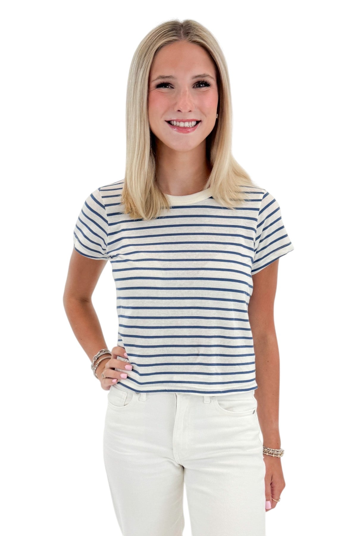 Front view of woman wearing Swagger Boutique’s True Navy Junie Striped Tee by Z Supply with jeans against white studio background.