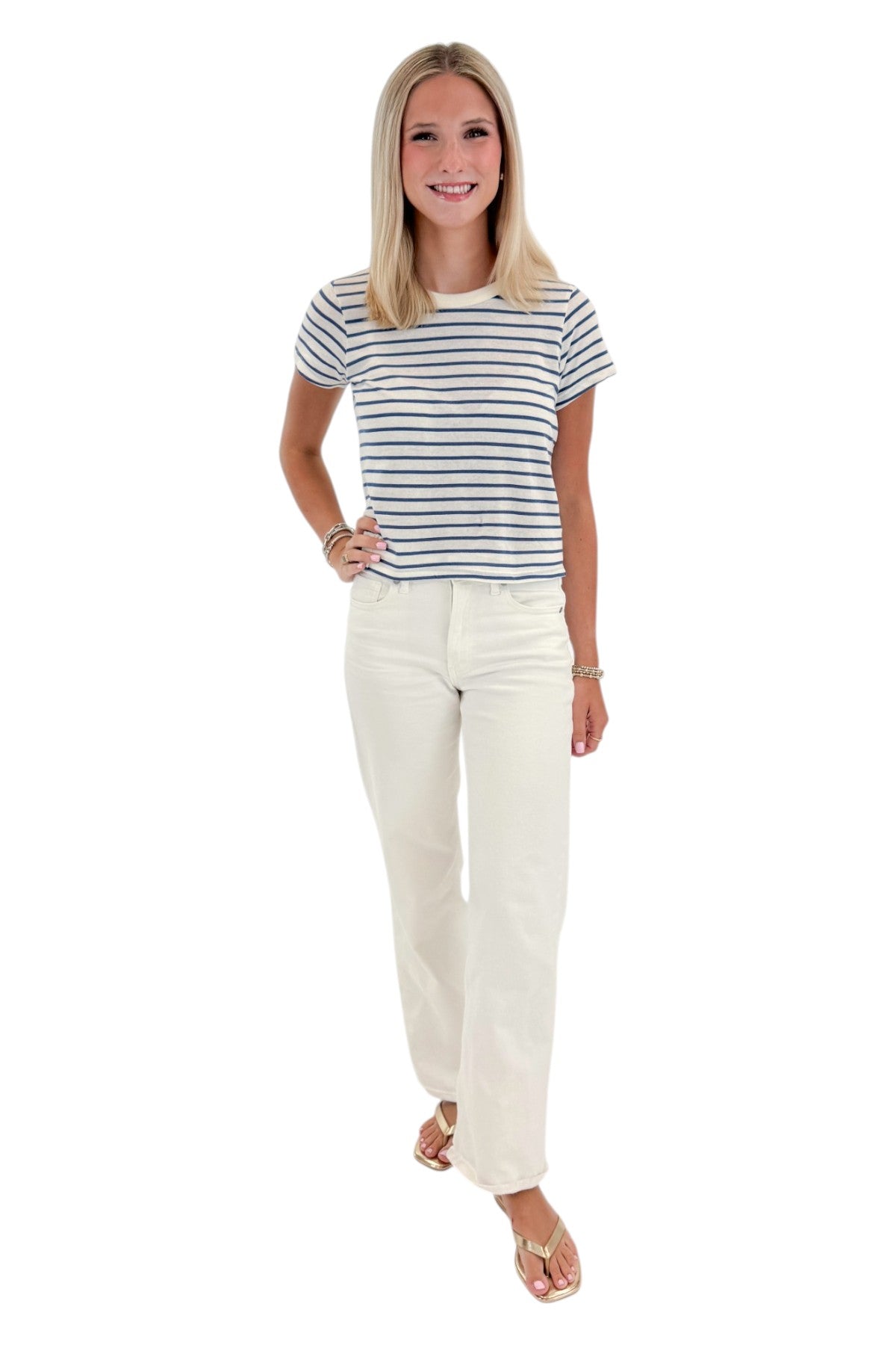 Front view of woman wearing Swagger Boutique’s True Navy Junie Striped Tee by Z Supply with jeans against white studio background.