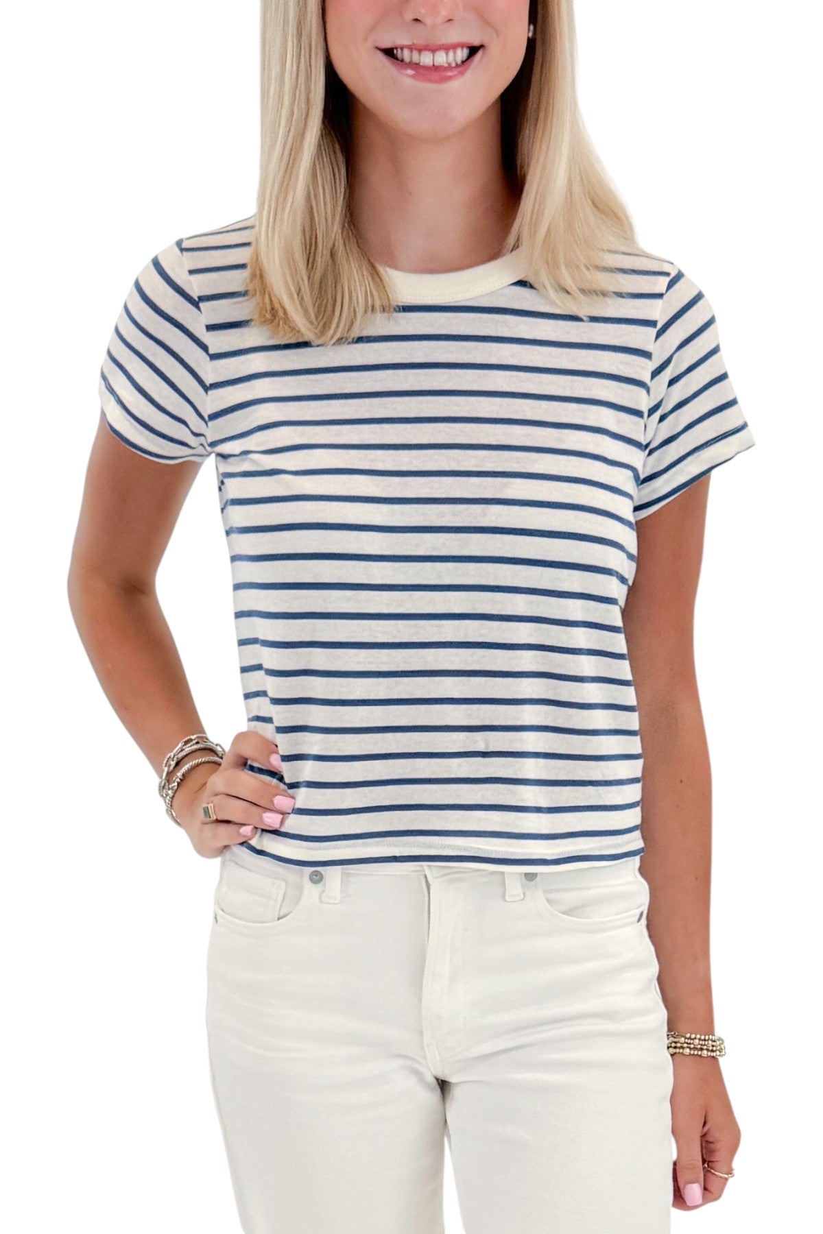 Front detail view of woman wearing Swagger Boutique’s True Navy Junie Striped Tee by Z Supply with jeans against white studio background.