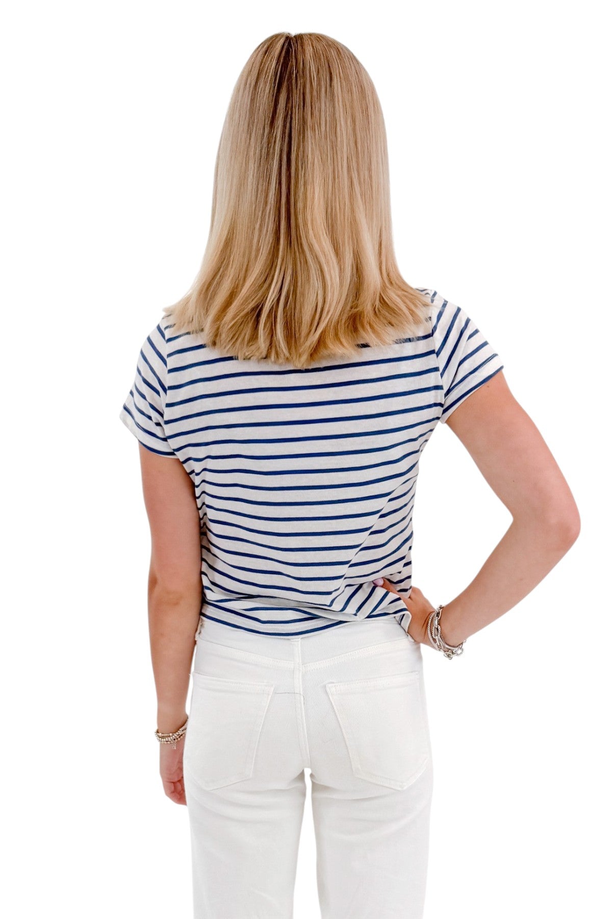 Back view of woman wearing Swagger Boutique’s True Navy Junie Striped Tee by Z Supply with jeans against white studio background.